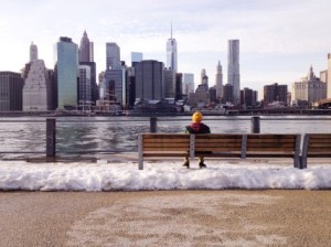 a-man-sits-on-a-bench-in-winter